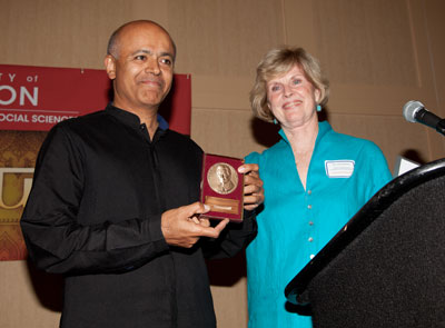 Dr. Verghese receiving award from Dr. Zamora