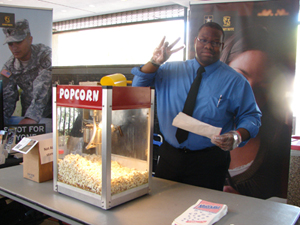 Ryan Johnson serves free popcorn courtesy of the office of Academic Affairs