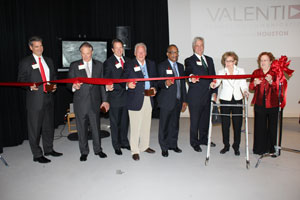 Valenti family, friends and faculty cut the ceremonial ribbon in the brand-new media production studio