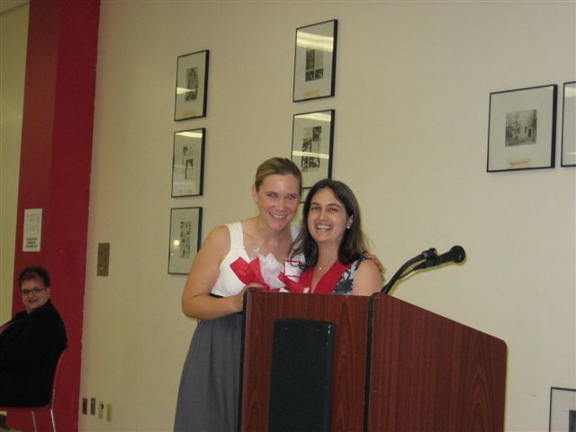 Kirsten Shipp and Dr. Rachel Aghara share a hug after Kirsten was awarded a ComD Scholar Certificate and a Research Recognition Award.