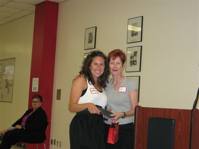 Sarah Burden being given the ComD Bliss Award by Dr. Stephanie Daniels, in recognition of previous Chair, Dr. Lynn Bliss.