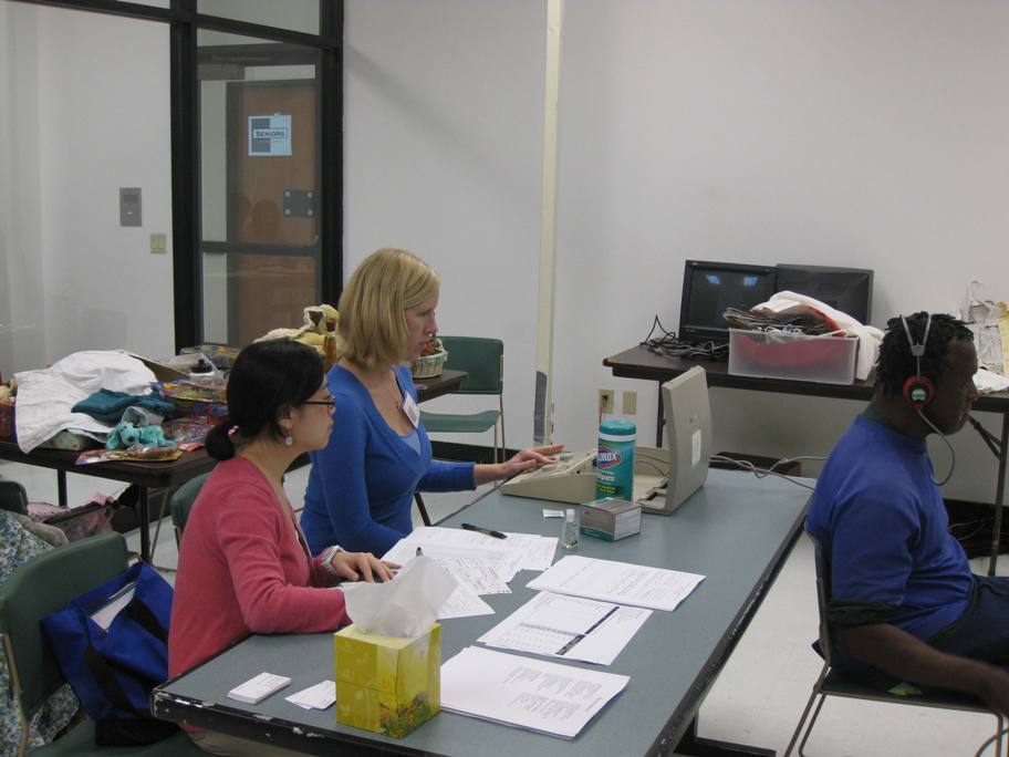 Graduate clinicians conducting a hearing screening