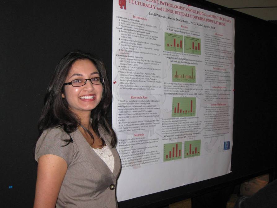 Sarah Panjwani next to her poster