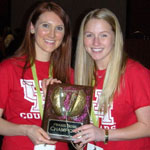 Graduate studens Kim Carlson and Liz Carmichael holding the TSHA Praxis Bowl trophy