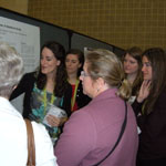 Graduate students Elizabeth Tatem, Margeux Rendall, Courtney Pape, and Amy Wasserman presenting their poster