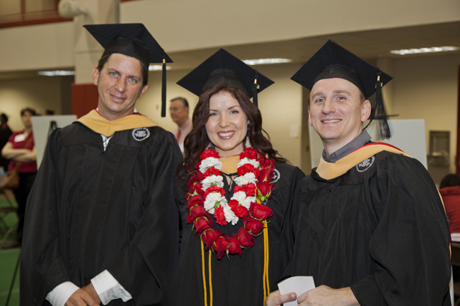 3 Graduates students posed before being conferred their master's degrees