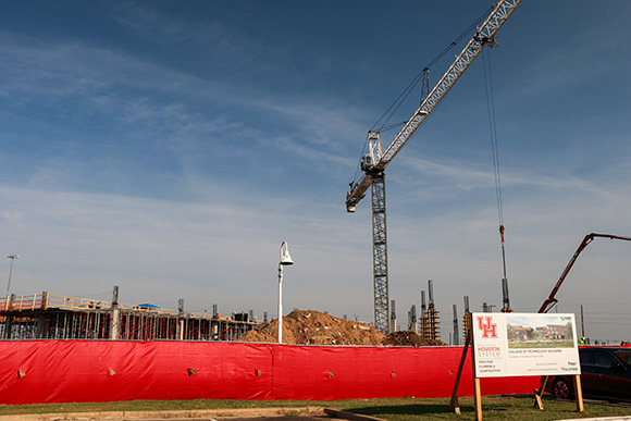 Large construction crane at a fenced in construction site