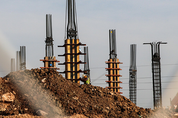 Pile of brown dirt in front of wire columns