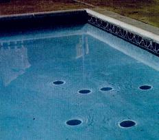 Falaco Solitons - Cosmological Strings in a Swimming Pool