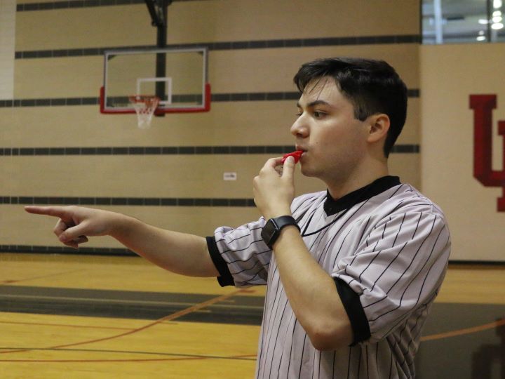 male official blowing whistle
