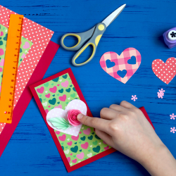 cand putting together a card with colorful paper scissors glue and tape