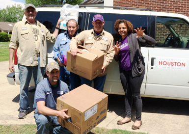 University of Central Arkansas staff members help UH Residence Life Coordinator Colette McFalls unload a van filled with donations from UH residential students to help victims of a deadly tornado.