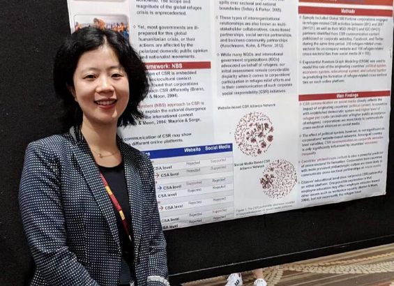Pictured: Dr. Wenlin Liu in presenting a poster at a conference. 
