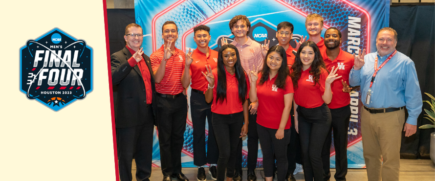 Sport Admin students and faculty pose happily with Final Four banner.