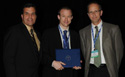 Dr. Brian McFarlin receives the award from ACSM president Dr. Robert Sallis (on the left) and Awards Chair Dr. Paul Davis (on the right).