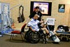 John Ward demonstrating the Electrical Stimulation Bicycle