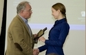  TACSM president Dr. Stephen Morris presenting an award to HHP grad student Emily LaVoy