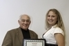 Dr. Bloom handing Amber Groll the award for outstanding undergraduate student, in Wellness/Fitness, for 2010