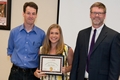 Mary Buckner winning an award for Excellence in Motor Behavior smiles for the camera, with Dr. Thrasher and Dr. Layne  