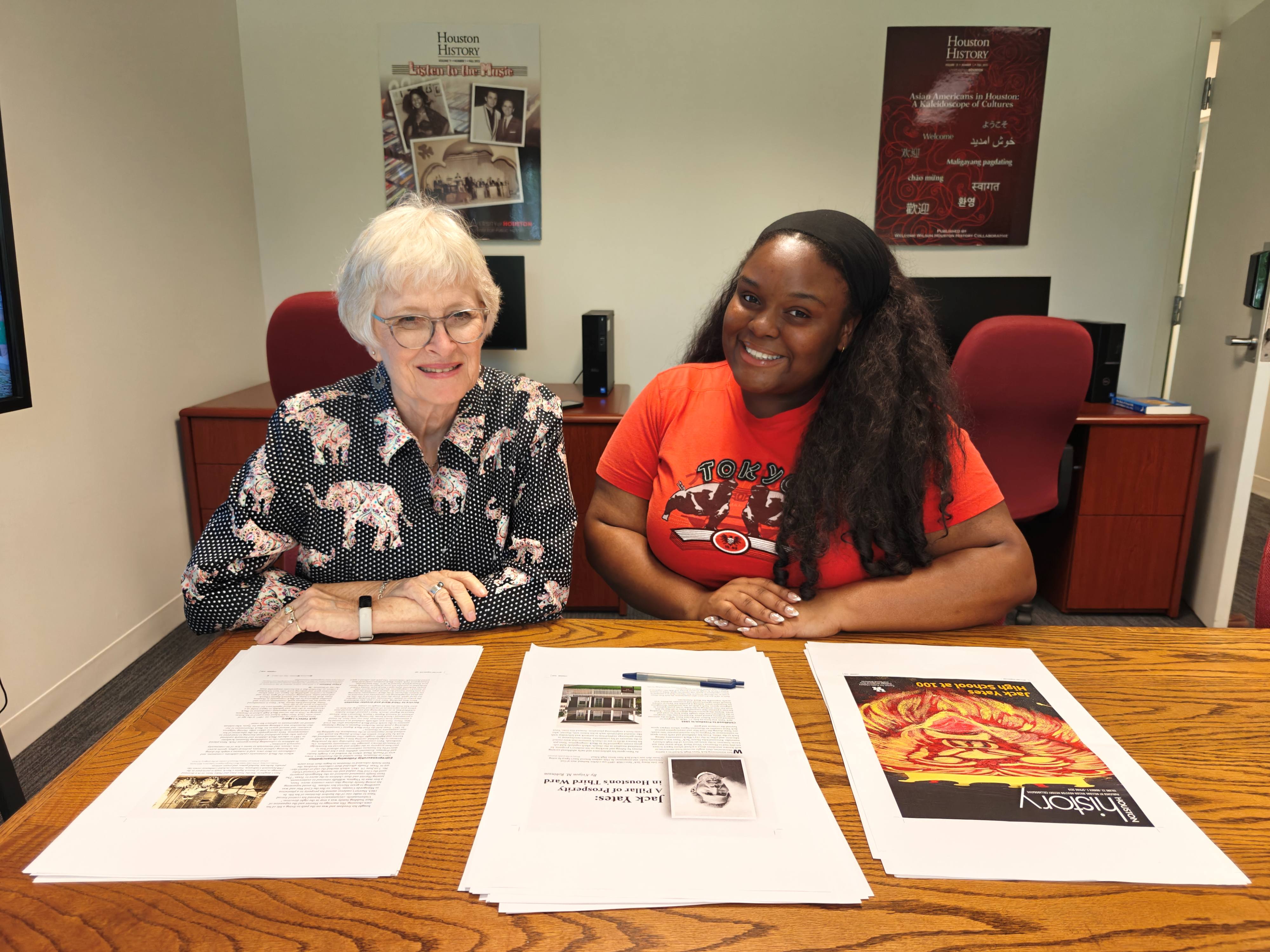 faculty and student researchers examine history magazine