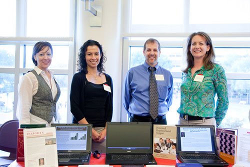 Display with Research books and authors standing behind of the display