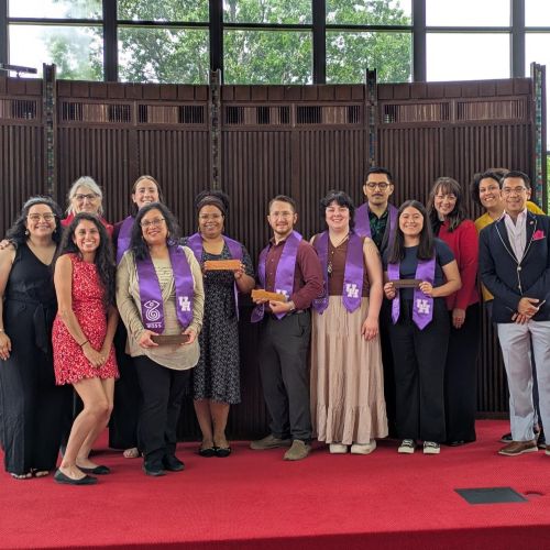 The 2025 graduates pose in their purple graduation stoles with the WGSS faculty and staff