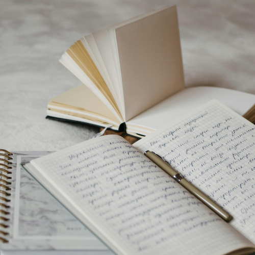 An open journal is full of handwritten notes