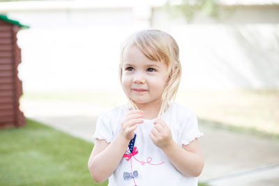 child outside playing with hair