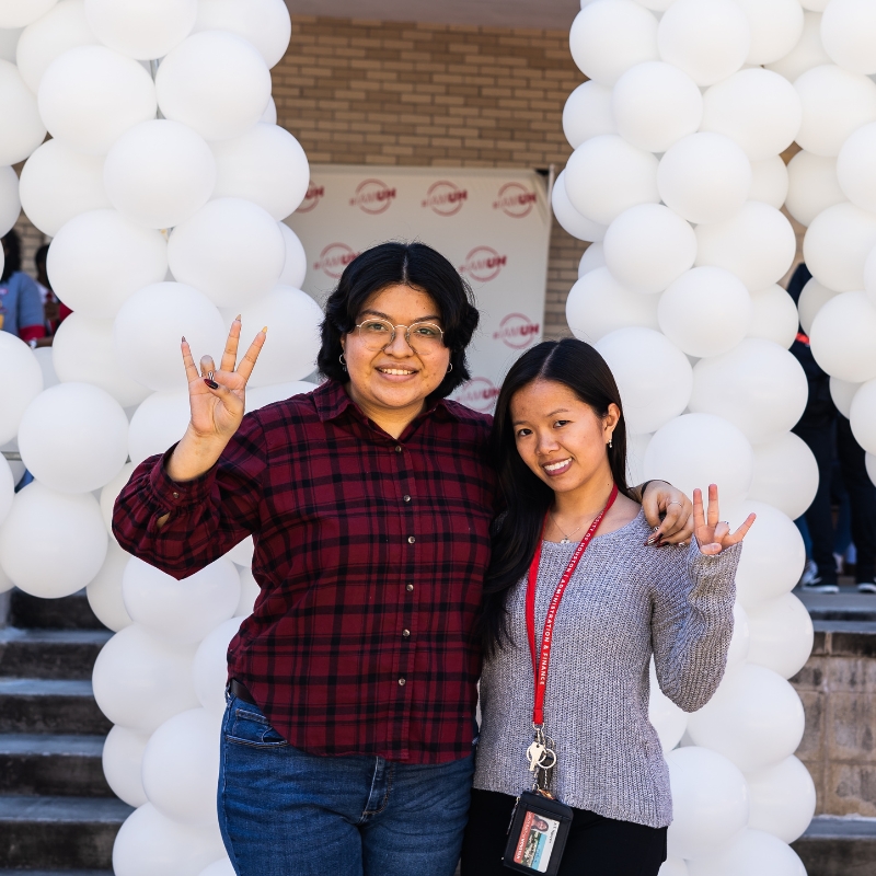 Posing in front of balloons