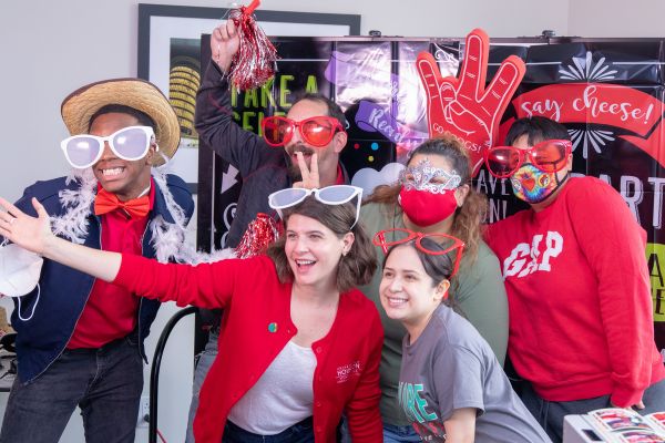 Students and staff having fun at a photobooth