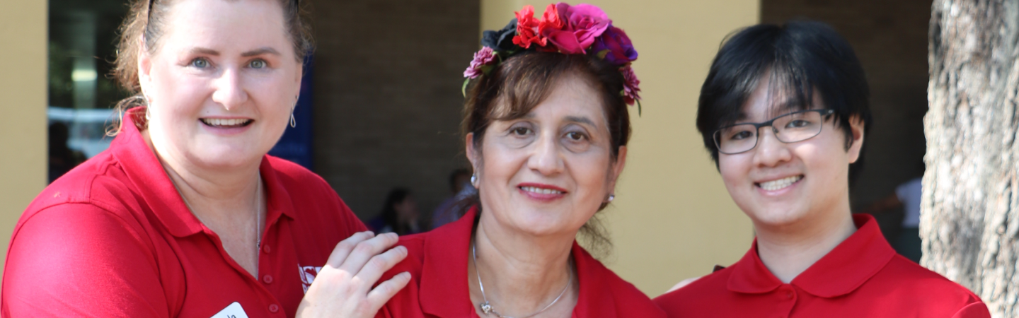 Three BOUNCE staff and intern members hugging