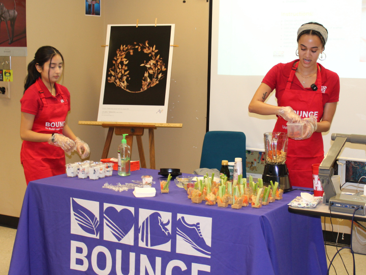 Two interns giving a food demonstration