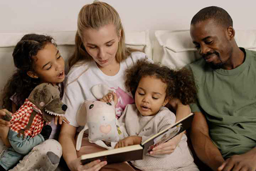 Woman and man reading to two children