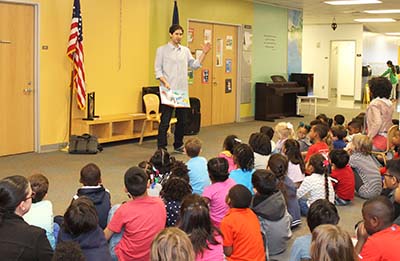 Matt de la Peña reading to students at the UH Charter School