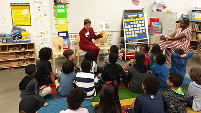 Rebecca Hoyt reads to UH Charter School children