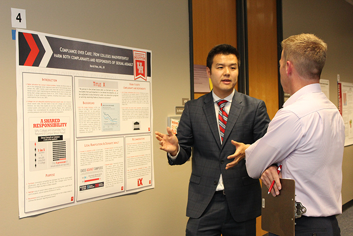 Doctoral student explaining his research