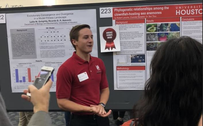 Robert Laroche presenting in front of his research poster