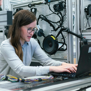 woman with glasses using laptop