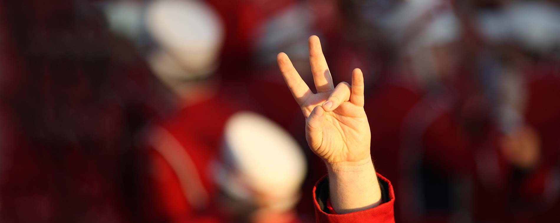 Close up of a student's hand in the "cougar paw" gesture.