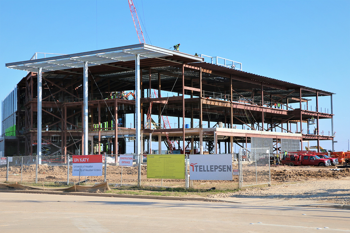 Structure of a building being completed by construction crew