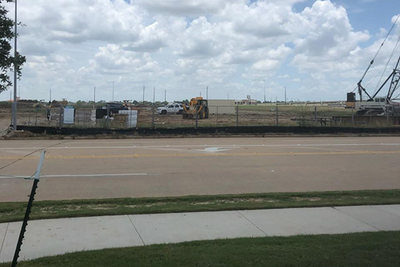 An empty road and land about to be constructed on