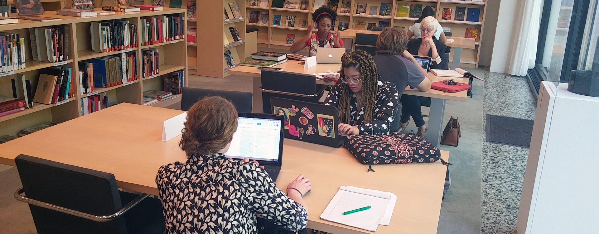 photograph of students studying in a library.