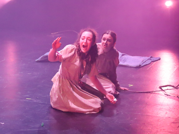 two actors kneeling on the ground