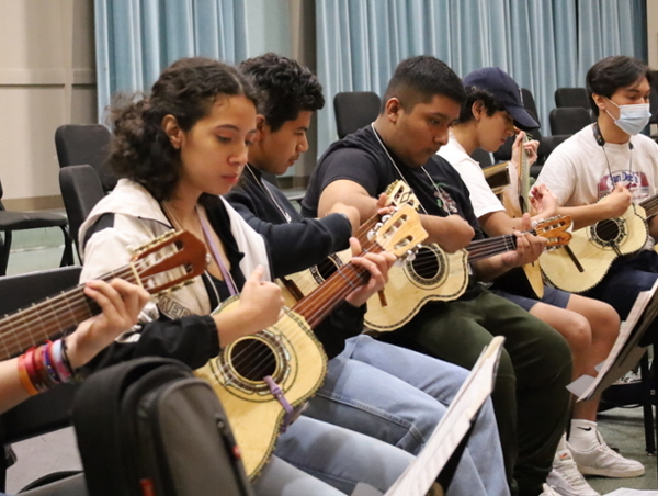 a group of guitar players