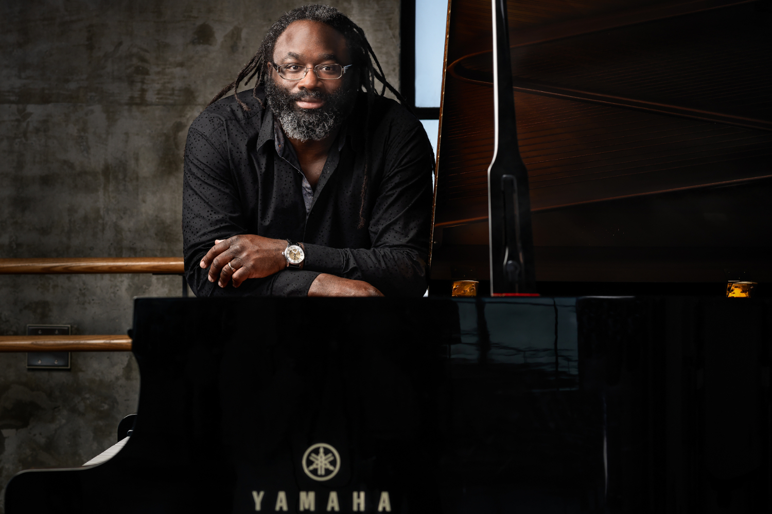 Awadagin Pratt standing at a Yamaha piano