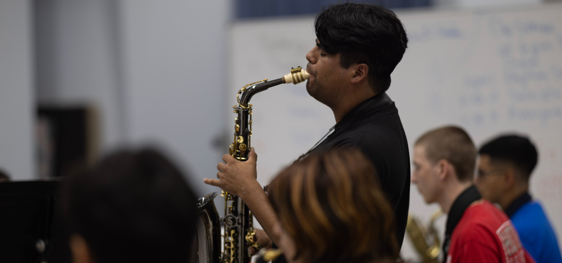 Saxophone player playing a solo with the Moores School of Music jazz band