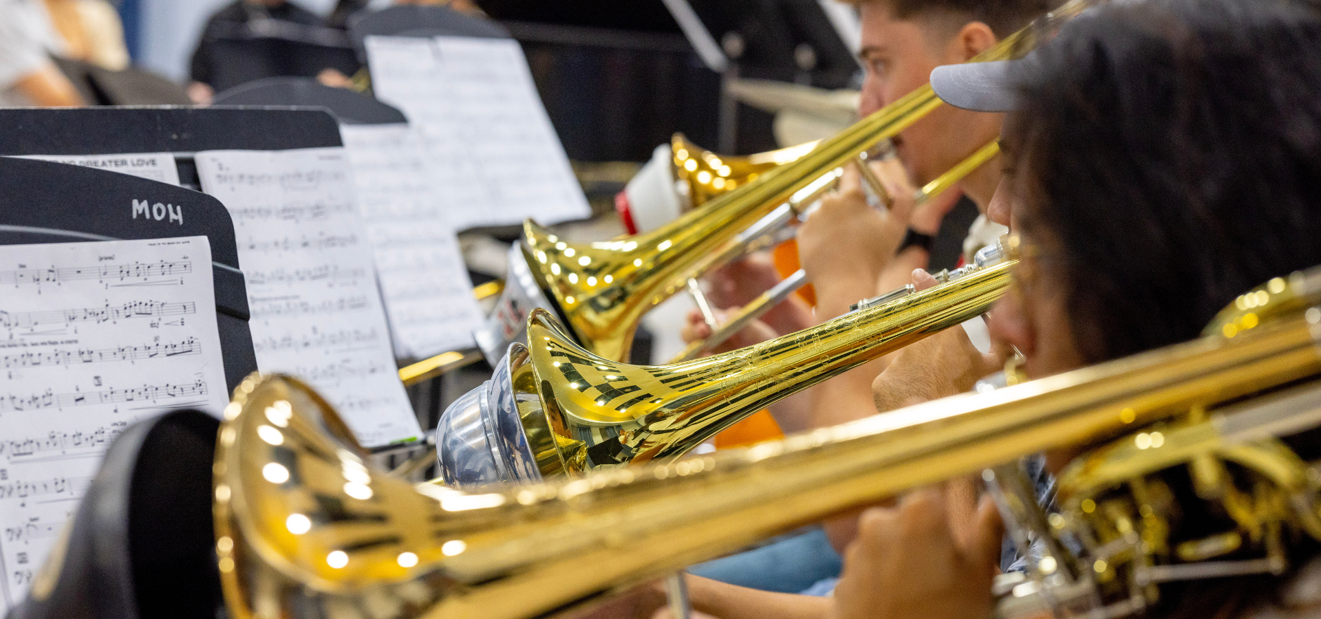 Jazz trombone section playing with mutes