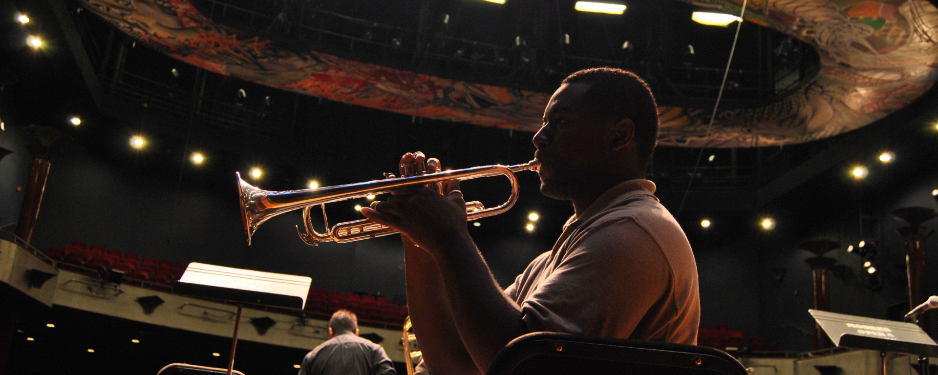 A trumpet player on the Moores Opera House stage