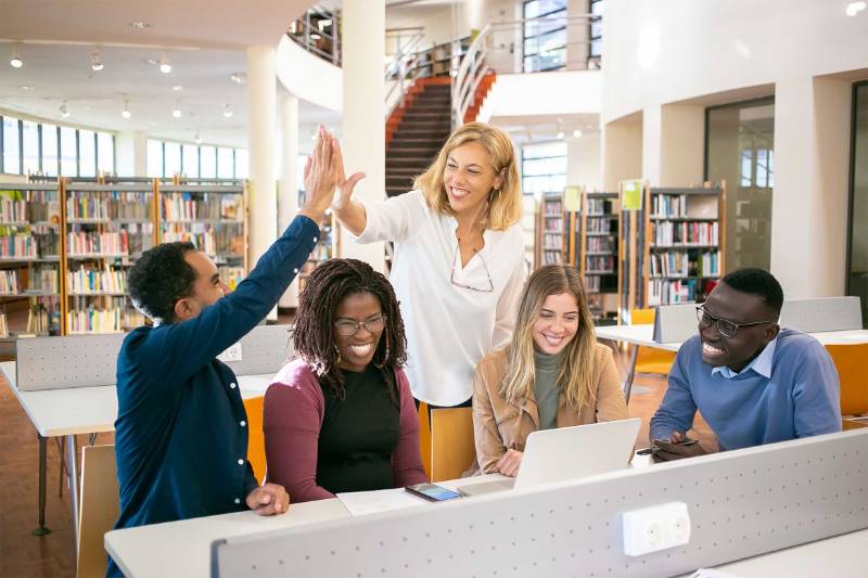 Students share a high-five