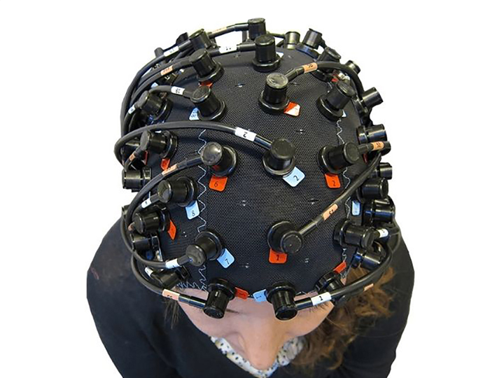 Person wearing head equipment measuring brain waves